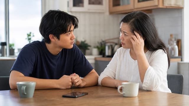 A young adult listens carefully to a family member asking about medication.