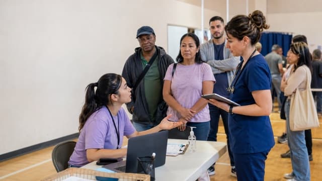 Community health volunteers manage limited appointment slots at an event.